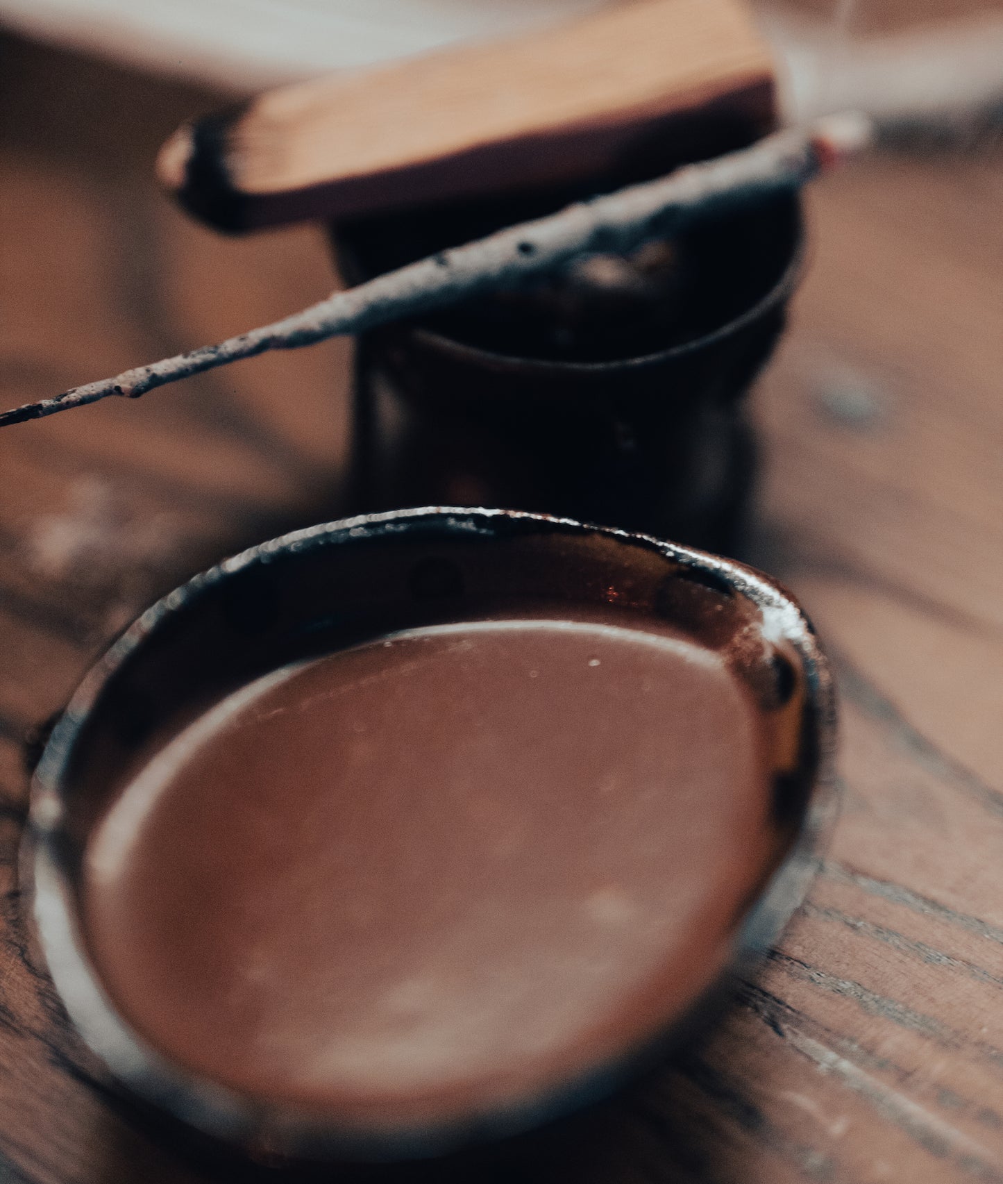 a cup of cacao, palo santo, and a copal incense stick
