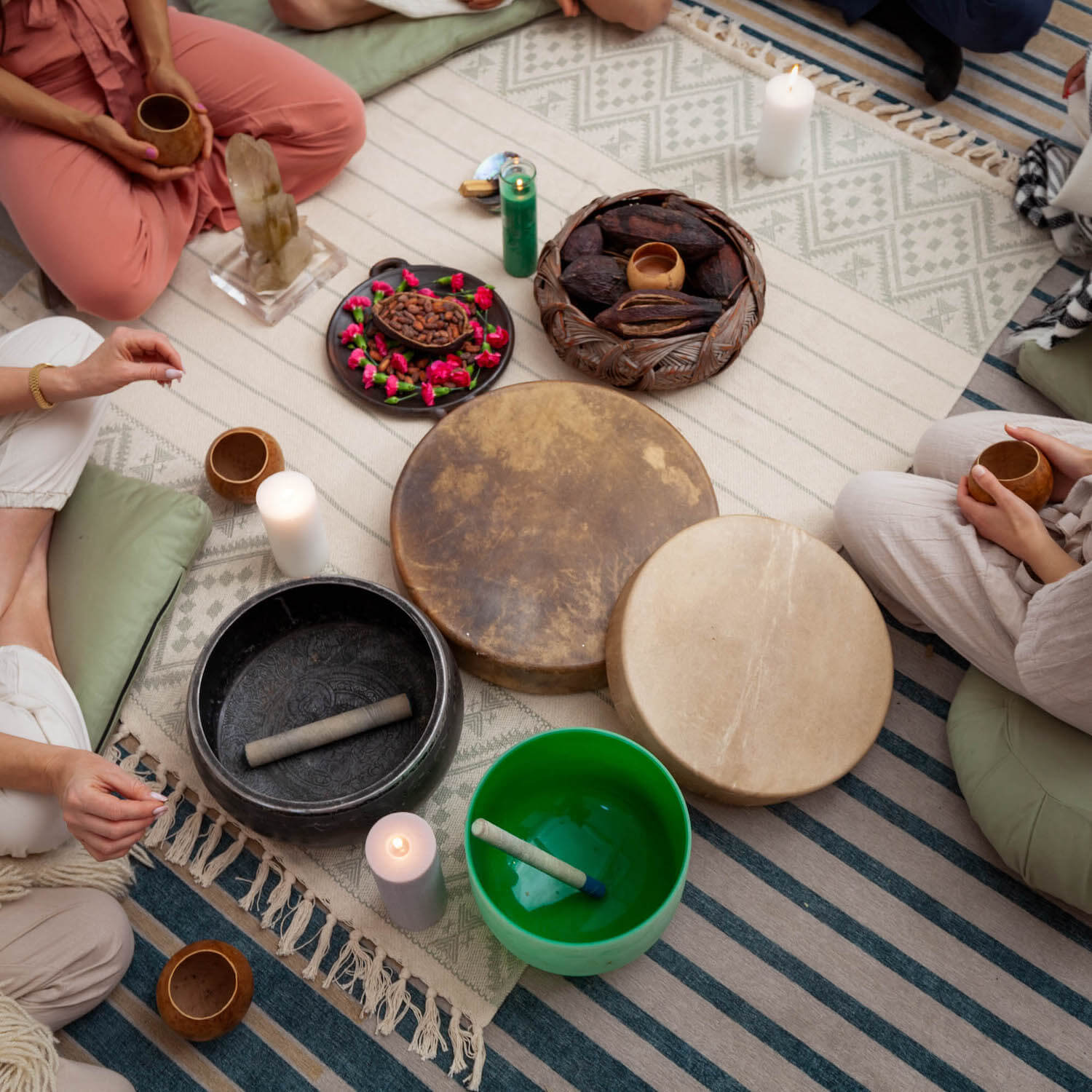 ceremonial altar setup with bowls and drums and candles