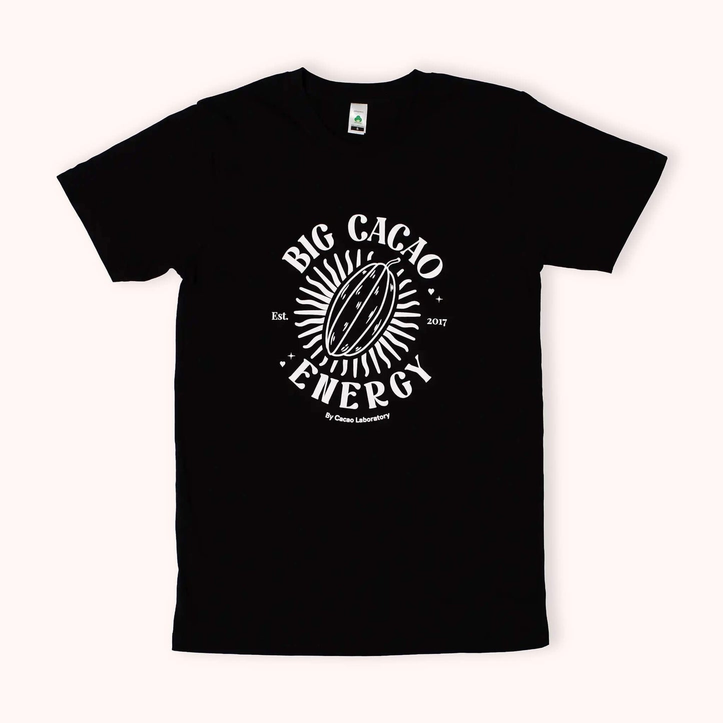 A black short-sleeve crewneck t-shirt featuring a white circular graphic on the chest with a cacao bean illustration and the text 'BIG CACAO ENERGY' and 'by cacao laboratory'.