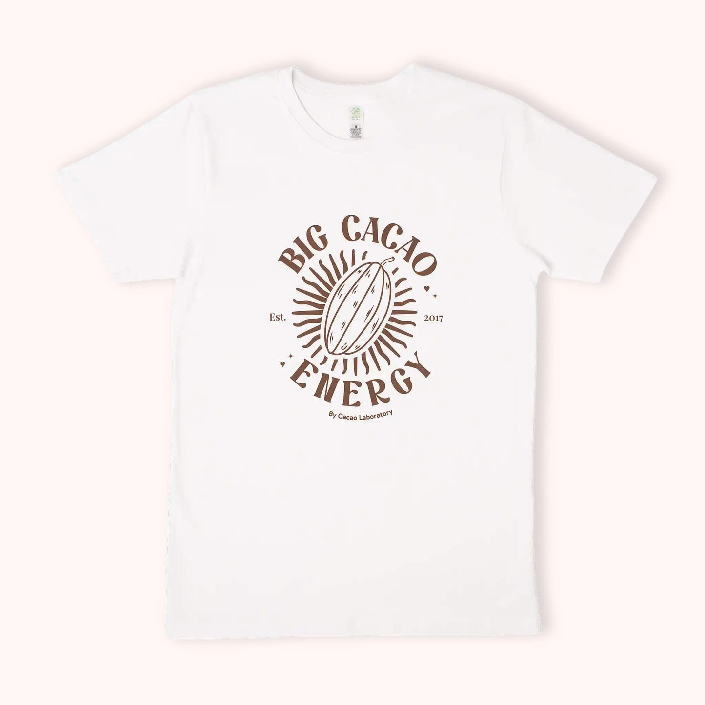 A white short-sleeve crewneck t-shirt featuring a brown graphic print on the front with a cocoa bean and the text 'BIG CACAO ENERGY' and 'By Cacao Laboratory'.