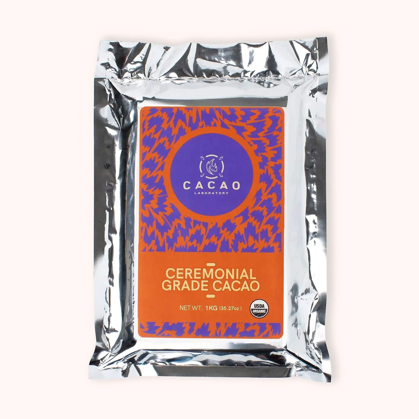 Cacao Laboratory ceremonial cacao block package with orange label and silver packaging on a white background