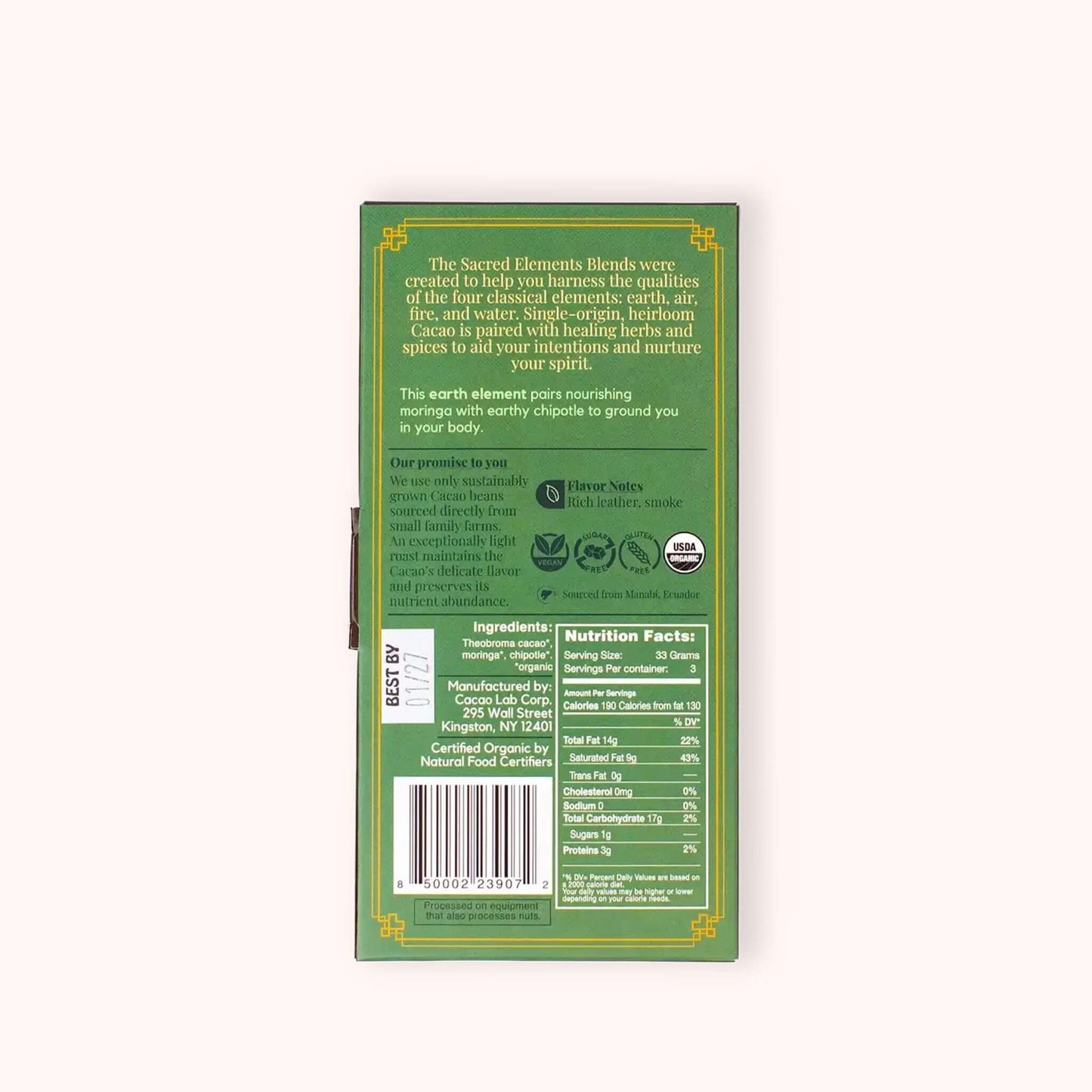The back of a green Sacred Elements ceremonial cacao box, showing product details, ingredients, nutrition facts, and a barcode on a light beige background.