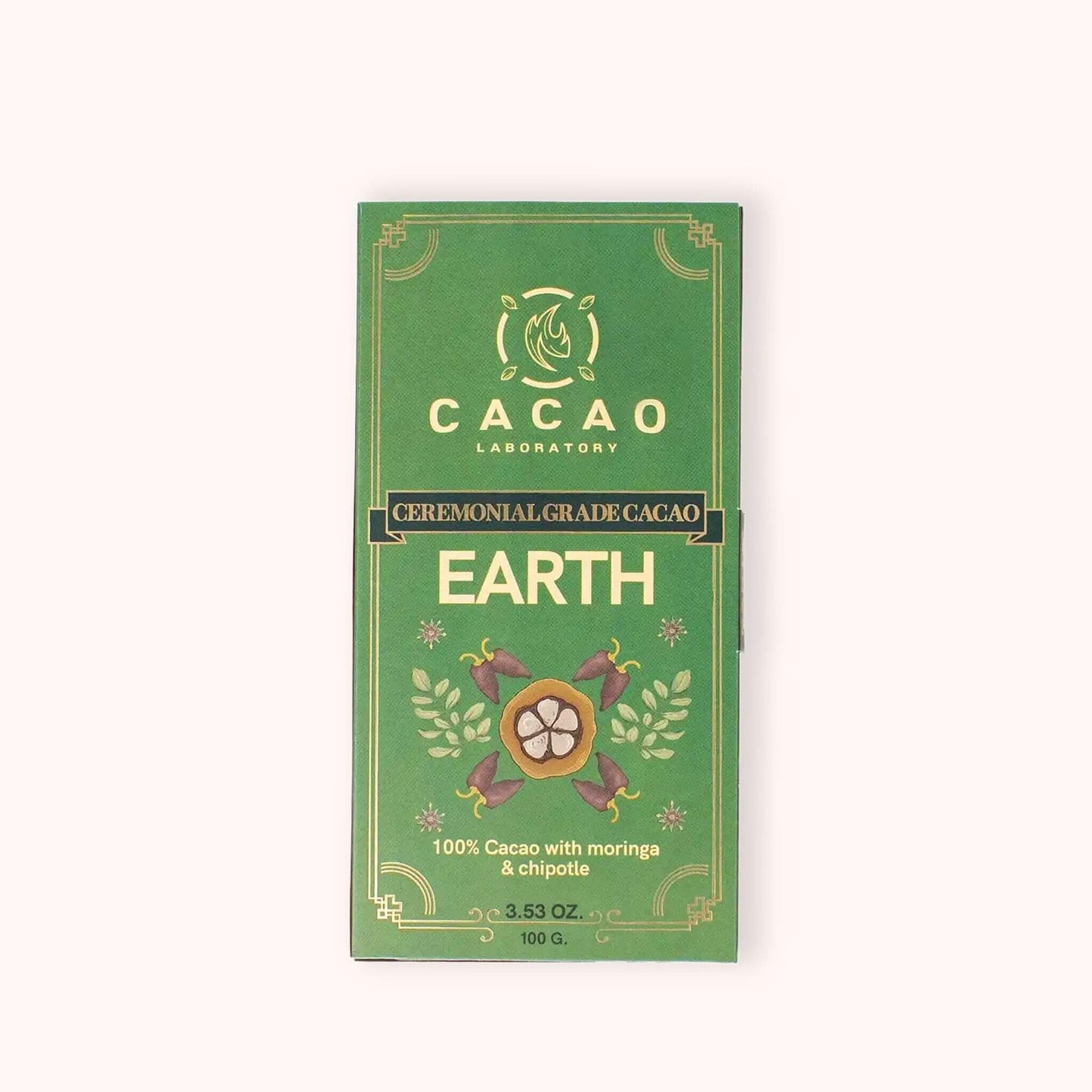 A green rectangular box of Cacao Laboratory Earth ceremonial grade cacao, featuring gold decorative borders and illustrations of cacao pods, set against a plain off-white background.