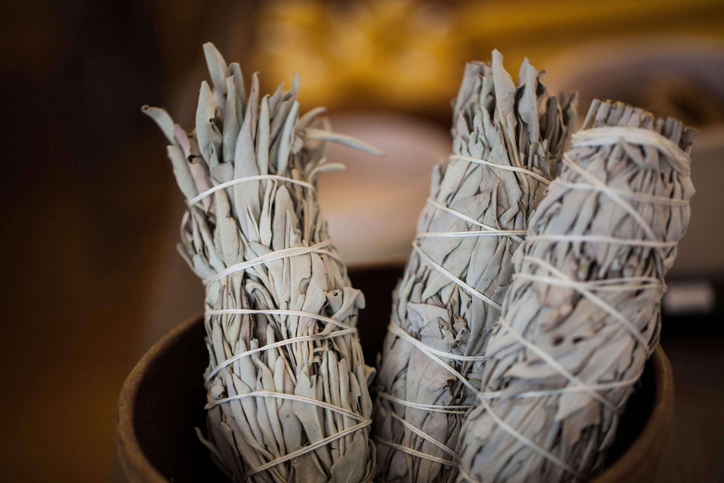 A bowl with wrapped sage for burning in ritual cleansing