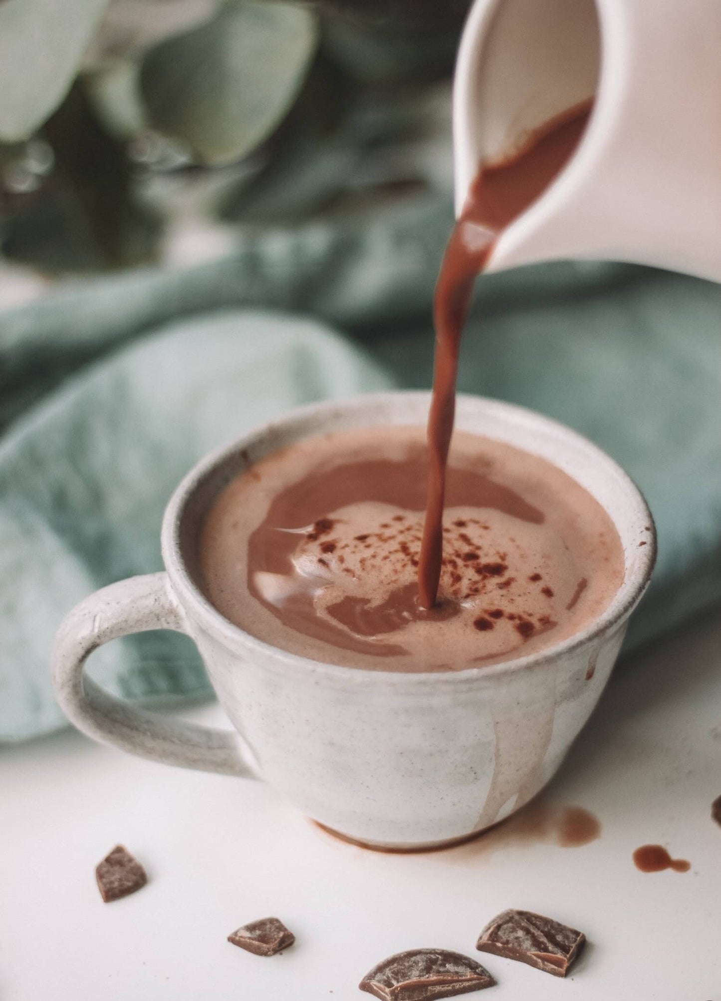 Ceremonial cacao poured into an earthenware cup