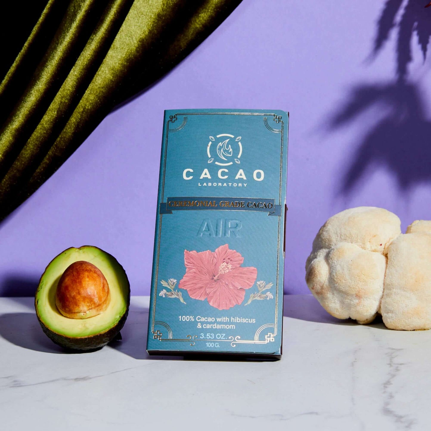 Cacao Laboratory cacao bar with an avocado and cauliflower on a purple background
